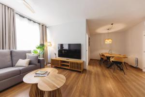 a living room with a couch and a table at Bravissimo Figuerola, Spacious 3-bedroom apartment in Girona