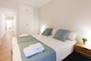 a bedroom with two beds with towels on them at Bravissimo Figuerola, Spacious 3-bedroom apartment in Girona