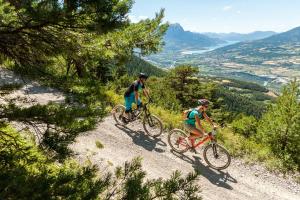 two people riding bikes on a mountain trail at Chalet le Chantelevent for 24 Guests - Slope Views, Pool & Jacuzzi in Vars