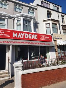 a mayden store with a red sign in front of a building at Maydene Hotel in Blackpool