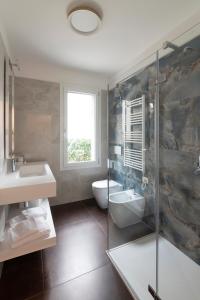 a bathroom with a sink and a toilet and a shower at Residence Cavalli in Mestre
