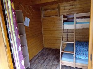 a room with two bunk beds and a ladder at ASTRA Lančov in Lančov