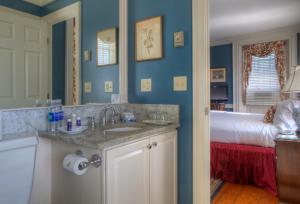 a bathroom with a sink and a bed in a room at Francis Malbone House in Newport +179 photos