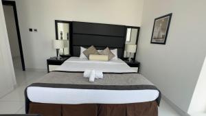 Postel nebo postele na pokoji v ubytování 2BR - SportsCity - Giovanni - Urban