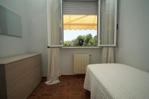 a bedroom with a bed and a large window at Casa Vacanze Le Terrazze in San Terenzo +30 photos