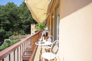 a balcony with two chairs and a table on it at Casa Vacanze Le Terrazze in San Terenzo