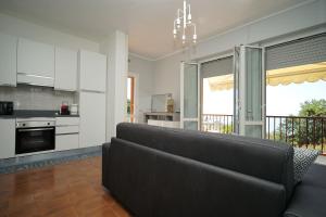 a living room with a black couch in a kitchen at Casa Vacanze Le Terrazze in San Terenzo