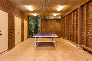 a ping pong table in a room with wooden walls at Tamanawas Cabin in Rhododendron