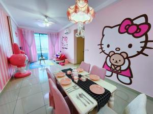 a dining room with a hello kitty mural on the wall at Puchong HELLO KITTY FULLY AIR-CON Suite in Puchong