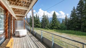 a balcony of a house with a view of the mountains at V DU BACHAT - Silene D11 in Chamrousse