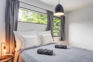 1 dormitorio con 1 cama grande y 2 almohadas en Villa Syreeni - Seafront/Jacuzzi, 