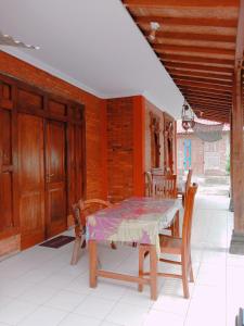 a table and chairs on the porch of a house at Rumah Ukhi in Yogyakarta