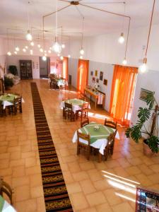 a dining room with tables and chairs and lights at Albergo Grumentum in Grumento Nova