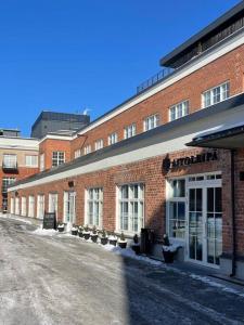 a large brick building with a street in front of it at Stunning 90 square meter apart with 3br + rooftop in Tampere