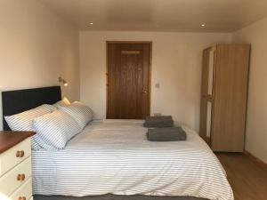 une chambre avec un grand lit avec deux oreillers dessus dans l'établissement Hendra Retreat Piglets Cottage North Cornwall, à Camelford