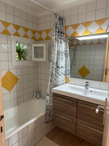 a bathroom with a tub and a sink and a bath tub at La Ramade de Saint-Tropez in Saint-Tropez