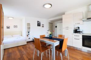 a kitchen and dining room with a table and chairs at PrimoPiano - Euclide in Milan