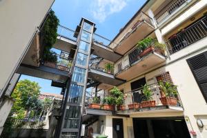 a ladder on the side of a building with potted plants at PrimoPiano - Euclide in Milan
