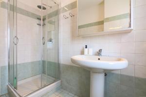 a bathroom with a sink and a shower at PrimoPiano - Euclide in Milan +40 photos