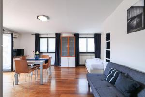 a living room with a couch and a table at PrimoPiano - Euclide in Milan