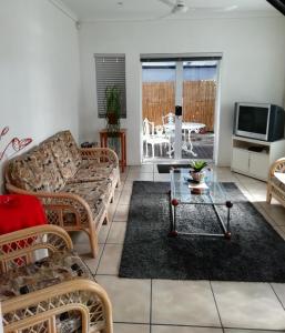 a living room with a couch and a table at ZEN Tree bed & breakfast in Paarl