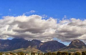 a group of mountains under a cloudy sky at ZEN Tree bed & breakfast in Paarl