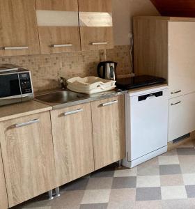 a kitchen with a sink and a microwave at GANCZ APARTMAN in Sárvár