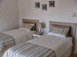 two beds sitting next to each other in a bedroom at ZEN Tree bed & breakfast in Paarl