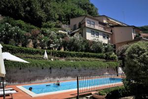 a large swimming pool in front of a building at Blue Lodge Lerici in San Terenzo