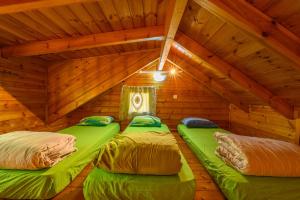 two beds in a room in a attic at Belfer's Dead Sea Cabins in Neʼot HaKikar