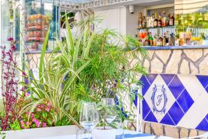 a table with glasses and plants in a restaurant at Hotel Florida in Sorrento