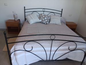 a bed with pillows on it in a bedroom at I Mancuso in SantʼAgata