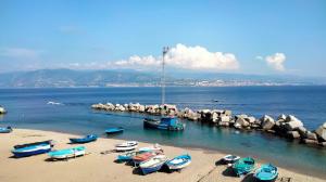 a group of boats on a beach in the water at I Mancuso in SantʼAgata