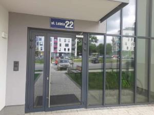 an entrance to a building with a sign above the doors at APARTAMENT OLIWIER in Kłodzko