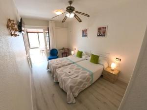 a bedroom with two beds and a ceiling fan at Pensión Pamplonabeds in Pamplona