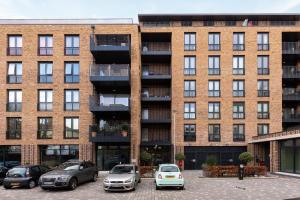 a brick building with cars parked in front of it at The Camden Apartment in London