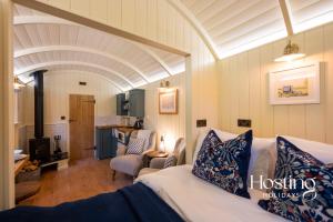a room with a couch and a living room at Red Kite Retreat - Pansy - Shepherds Hut 3 in Henley on Thames