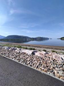 a road next to a large body of water at A view to Caol, Fort William in Fort William