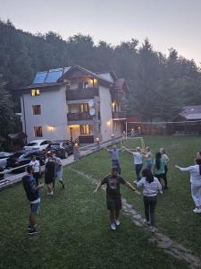 un grupo de personas jugando un juego de frisbee en Pensiunea Zece Brazi Cheia en Măneciu
