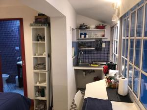 a kitchen with a sink and a table in a room at Monoambiente con baño privado y cocineta dentro de casa in Buenos Aires