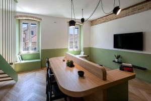 a living room with a wooden table and a tv at Dimora Condivi in Ripatransone