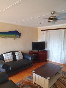 a living room with a couch and a coffee table at Dibiki Holiday Resort in Hartenbos
