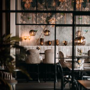 Sunlight Hotel Conference & Spa في نيكوبينغ: غرفة طعام مع طاولة وكراسي وأضواء