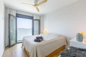 a white bedroom with a bed and a large window at A&N Sea View Apartment with Pool & Parking Torre del Mar in Torre del Mar +97 photos