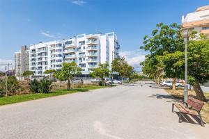 a street in front of a large white building at A&N Sea View Apartment with Pool & Parking Torre del Mar in Torre del Mar