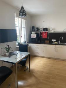 a kitchen with a table and a dining room at City Apartment Dresden in Dresden