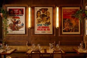 a dining room with posters on the wall at Esme Miami Beach in Miami Beach