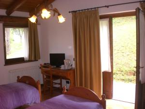 a bedroom with a bed and a desk with a computer at Bed And Breakfast Montino in Cene