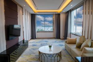 a living room with a couch and a table at ST Hotel Wattay Airport in Vientiane