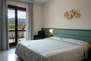 a hotel room with a bed and a balcony at Hotel Pian del Sole in Sassello +62 photos